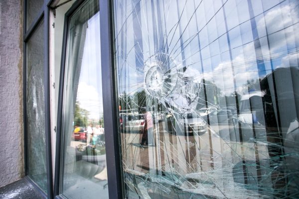 broken glass window of the modern building reflecting blue sky