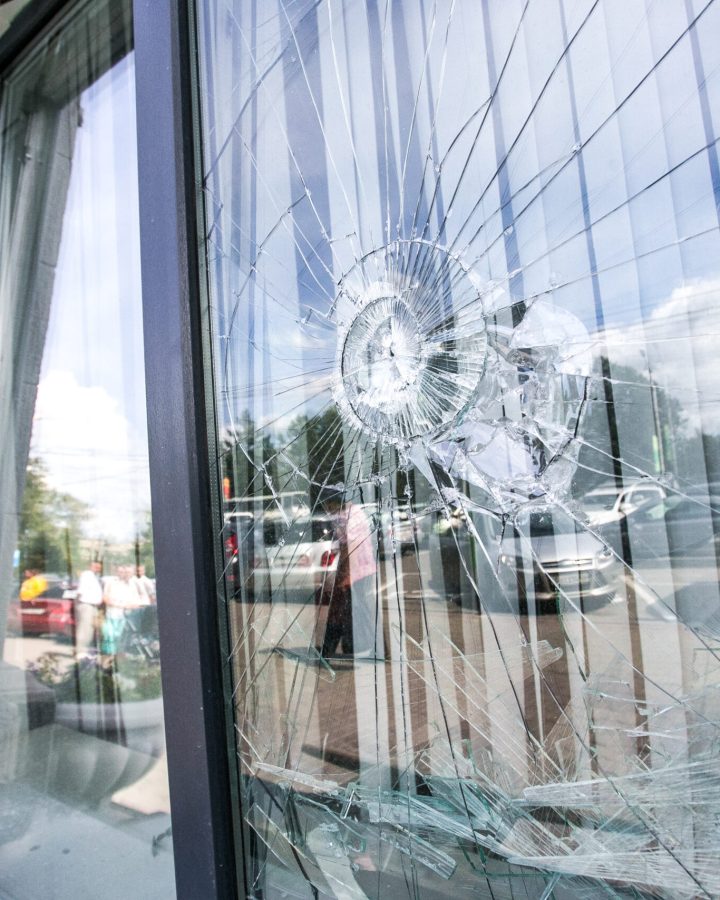 broken glass window of the modern building reflecting blue sky