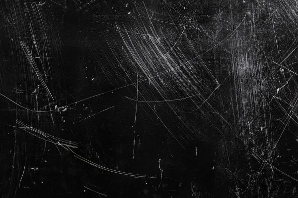 White scratches and dust on black background. Old dirty glass.